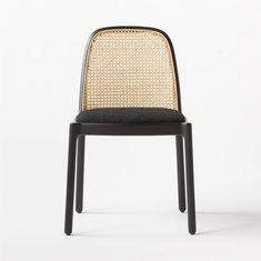 a black chair with a woven back and seat cushion on the front, viewed from the side