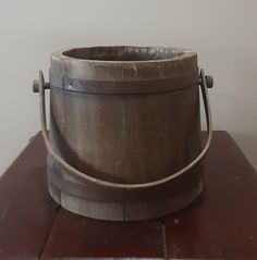 a wooden bucket sitting on top of a table