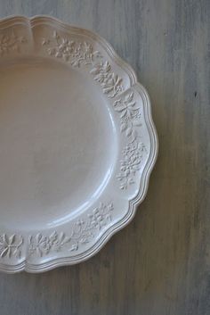 a white plate sitting on top of a wooden table