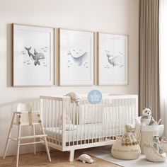 a baby's room with three framed pictures on the wall