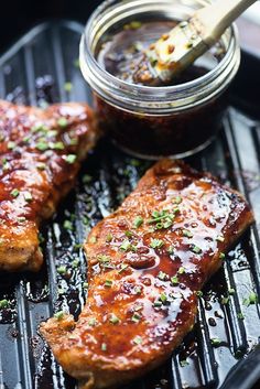 grilled pork chops with bbq sauce on the grill, ready to be eaten