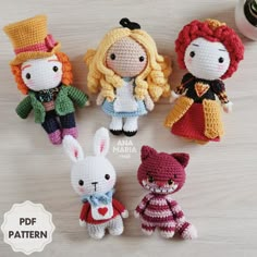 four crocheted dolls are sitting next to each other