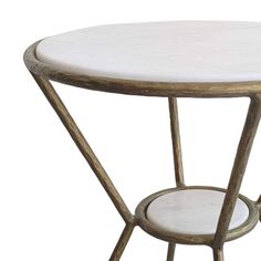 a white marble top side table with gold metal frame and two circular trays on each side