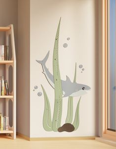 a room with a book shelf and wall decal in the shape of a shark