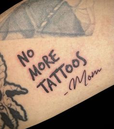 a close up of a person's arm with tattoos on it and writing that says no more tattoos