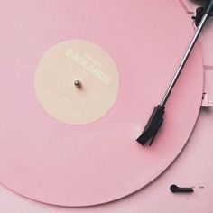 a pink record player with an umbrella on top of it and some screwdrivers