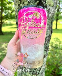 a hand holding up a pink and gold glitter tumbler with the words bad please on it