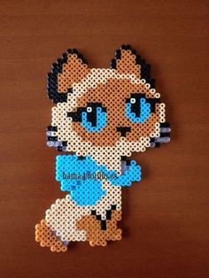 a cat made out of perler beads sitting on top of a table