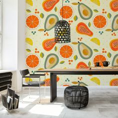 a dining room table with fruit wallpaper in the background