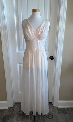 This is the most beautiful and glamorous vintage Vanity Fair nightgown. This is one of my favorite pieces. It is the ultimate in Hollywood glamour. It is a light peach or apricot color. It is sheer with lovely lace floral embellishments. Based on the label, it was made in the 1950s. The bust is 36 inches. The waist is 29 inches. The total length is 53 inches. The bust and waist measurements are very stretchy. 1950s Nightgown, 1950s Vanity, Vintage Vanity Fair, Apricot Color, Women's Nightgowns, Pajama Robe, Vintage Vanity, Light Peach, Hollywood Glamour