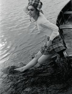 a woman sitting on top of a boat in the water