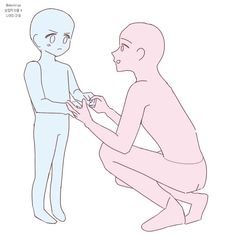 a man kneeling down next to an alien holding something in his hand and touching it