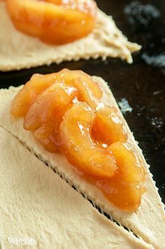 two pieces of bread with fruit on them