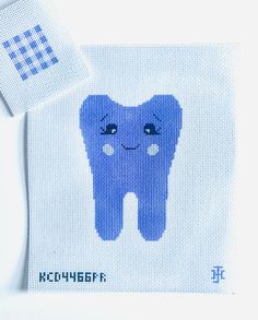 a cross stitch tooth on a white background