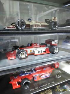 some model cars are on display in a case