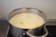 a pot on top of a stove filled with liquid