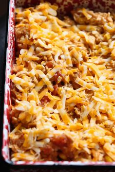 a casserole dish filled with cheese and meat