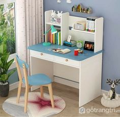 a child's desk and chair in a room with a potted plant on the floor