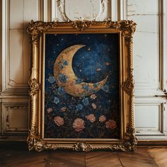 an ornate gold frame holds a painting of a moon and flowers