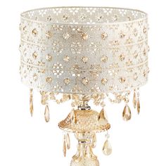 a white table lamp with gold trimmings and crystal drops on the shade,