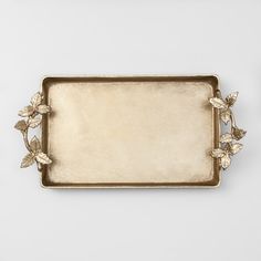 a gold tray with leaves on it