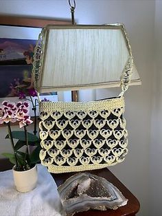 a purse sitting on top of a table next to a lamp