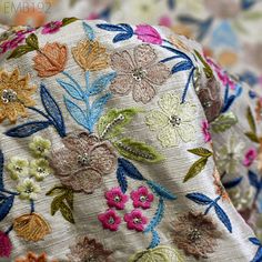 a close up view of the back of a hat with flowers and leaves on it