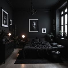 a bedroom with black walls and pictures on the wall