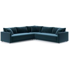 a blue sectional couch with pillows on the top and bottom corner, facing away from the camera