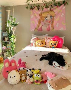 a bed with lots of stuffed animals on it and a pink wall hanging over the headboard