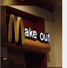 a mcdonald's sign that says take out above the counter in front of it