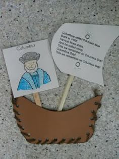 a paper cut out of a man with a hat on top of a toothpick