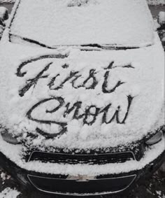 a car covered in snow with the words first snow written on it