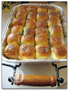 a pan filled with rolls sitting on top of a stove