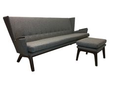 a gray couch and ottoman sitting next to each other