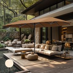 an outdoor living area with couches, tables and umbrellas on the decking