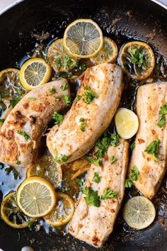 fish with lemons and parsley in a skillet