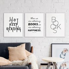 three black and white posters on a brick wall above a couch with pillows, coffee table and side table