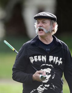 an older man with a baseball bat in his hand