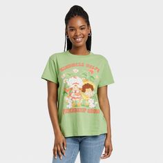 Enjoy a comfortable feel and laid-back style with this Women's Strawberry Shortcake Kindness Graphic T-Shirt- Green. Featuring a crew neck and short sleeves, this tee is easy to pair with jeans, jeggings, shorts and more. It has Strawberry Shortcake with the 'Kindness helps friendship grow' print. This Women's Strawberry Shortcake Kindness Graphic T-Shirt- Green will surely become a go-to essential for daily wear. Summer Graphic Tee With Strawberry Print, Strawberry Print Graphic Tee With Crew Neck, Strawberry Shortcake Shirt, Cute Short Sleeve T-shirt With Strawberry Print, Summer Strawberry Print Graphic Tee, Strawberry Shortcake Shirt Vintage, Kindness Graphic, Barbie Logo, Green Strawberry