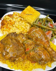 a white plate topped with meat and rice