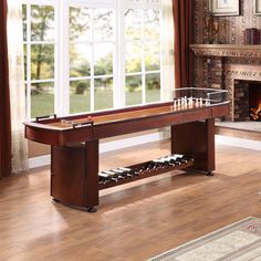 a living room with a fire place and a pool table in the middle of it