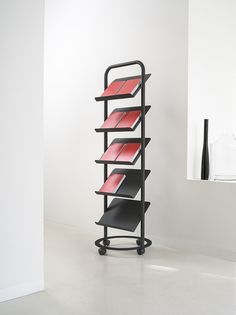 a black and red shelf sitting on top of a white floor