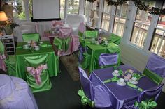 tables and chairs covered in purple and green cloths with bows on them, set up for a party