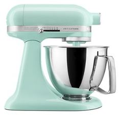 a mint green kitchen mixer on a white background with the words manhattania written in silver