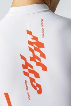 the back of a man's shirt with an orange and white print on it