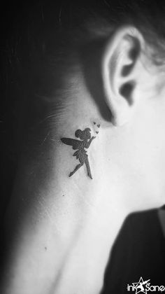 a small tattoo on the neck of a woman