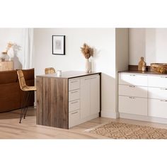 a kitchen with white cabinets and wooden floors