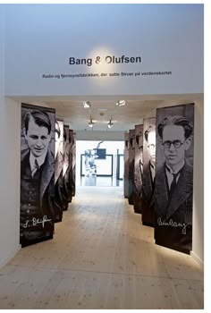 the entrance to an art gallery with black and white portraits