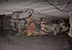 an old truck is in the middle of a tunnel with it's hood up